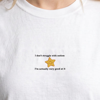 I don't struggle with autism embroidered t-shirt, worn, close-up of the stitching