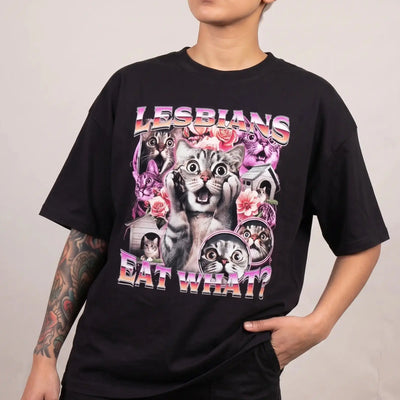 Model wearing the Lesbians Eat What T-Shirt in black, studio photo