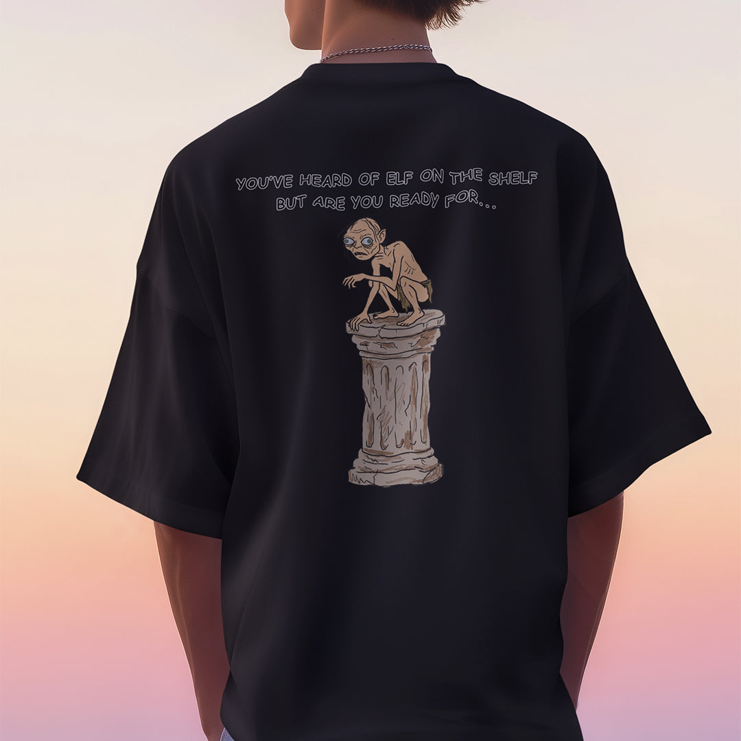You've heard of elf on the shelf but are you ready for Gollum on a Collumn T-Shirt (backprint) Orbital Clothing