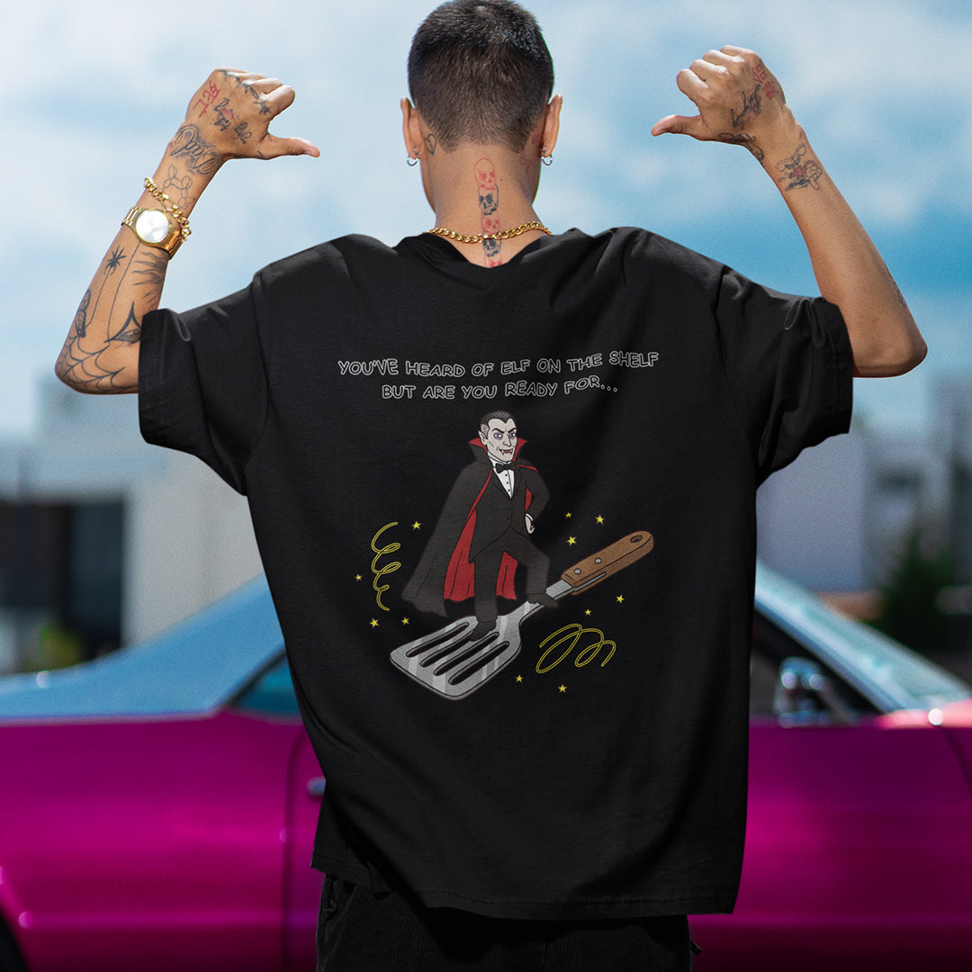 You've heard of elf on the shelf but are you ready for Dracula on a Spatula T-Shirt (backprint) Orbital Clothing