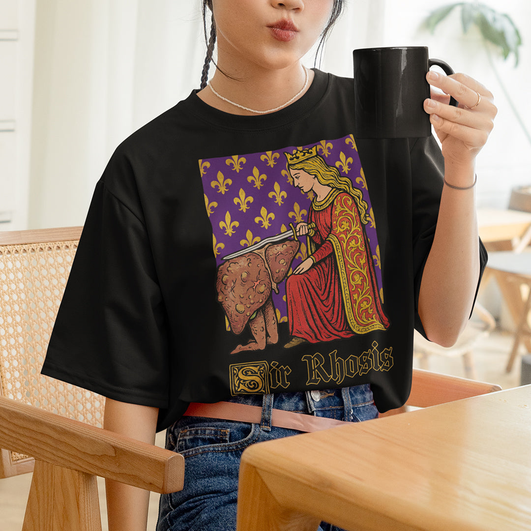 Person wearing a black t-shirt with a graphic design, holding a mug indoors.