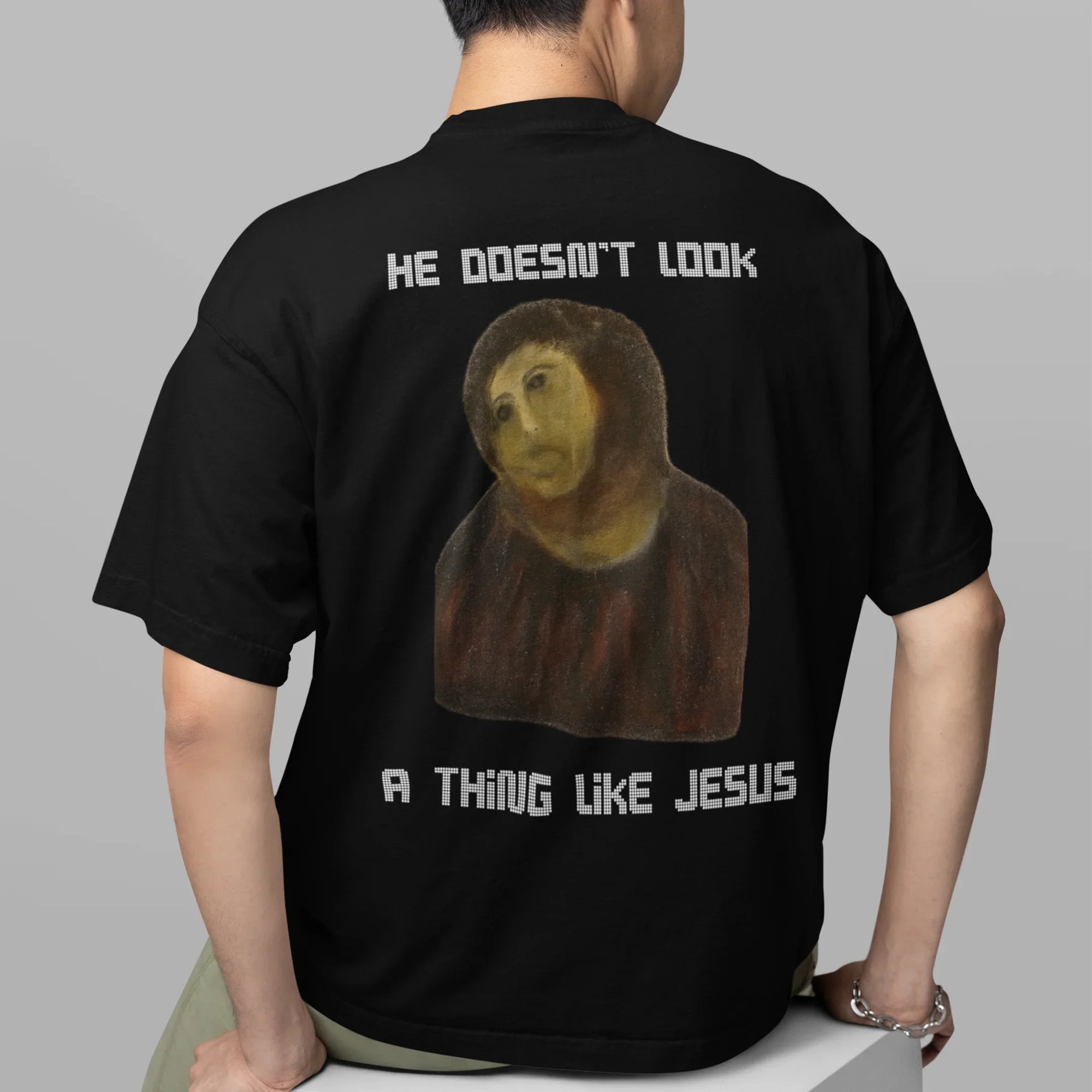 He doesn't look a thing like Jesus T-Shirt (backprint) - Orbital Clothing