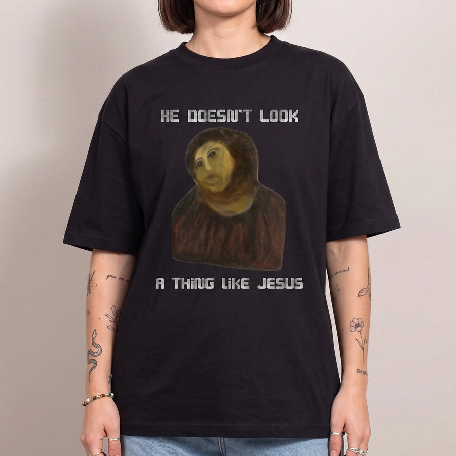 He doesn't look a thing like Jesus Funny T-Shirt - Orbital Clothing