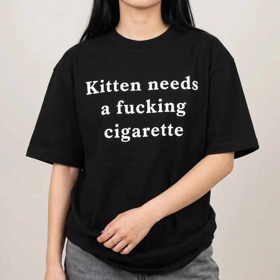 Model wearing the Kitten needs a cigarette T-Shirt in black, studio photo