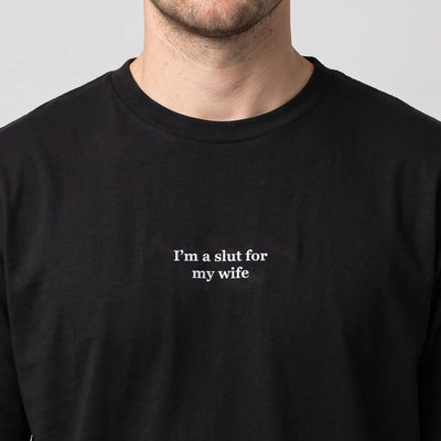 I'm a slut for my wife embroidered t-shirt in black, worn, close-up of the stitching