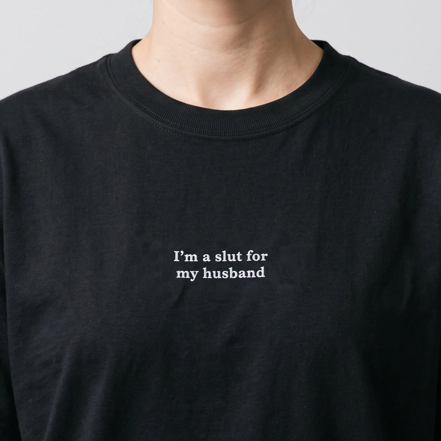 I'm a slut for my husband embroidered t-shirt in black, worn, close-up of the stitching