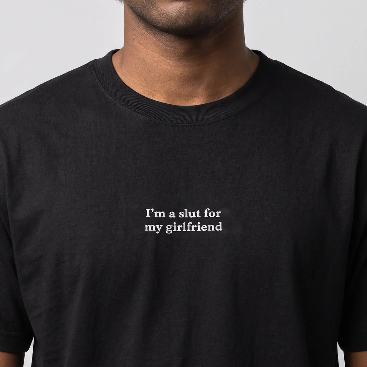I'm a slut for my girlfriend embroidered t-shirt in black, worn, close-up of the stitching