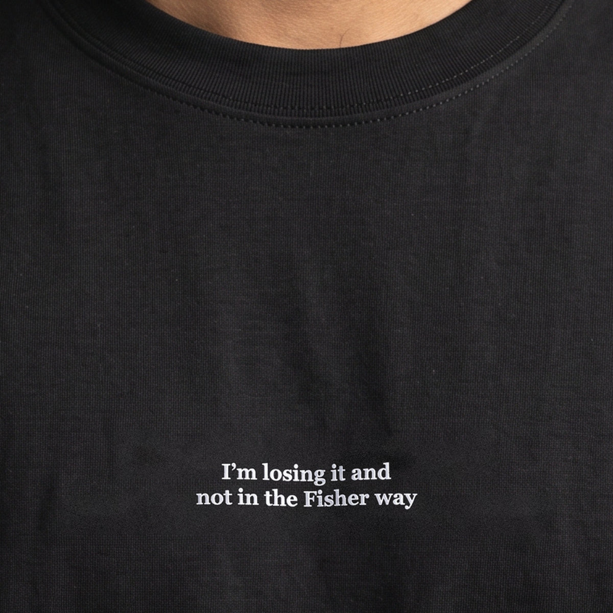 I’m losing it and not in the Fisher way (embroidered) T-Shirt in black, worn, close-up of the stitching