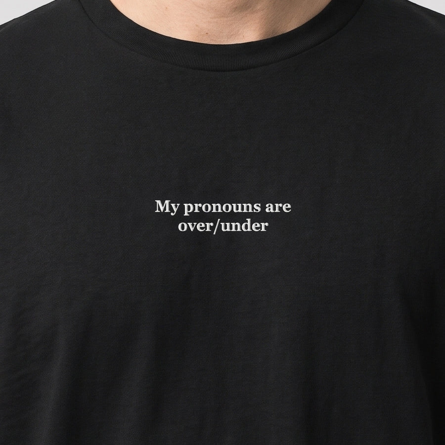My pronouns are over/under (embroidered) T-Shirt in black, worn, close-up of the stitching