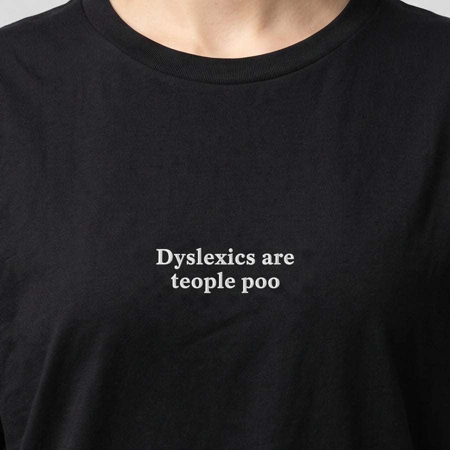 Dyslexics are teople poo embroidered t-shirt in black, worn, close-up of the stitching