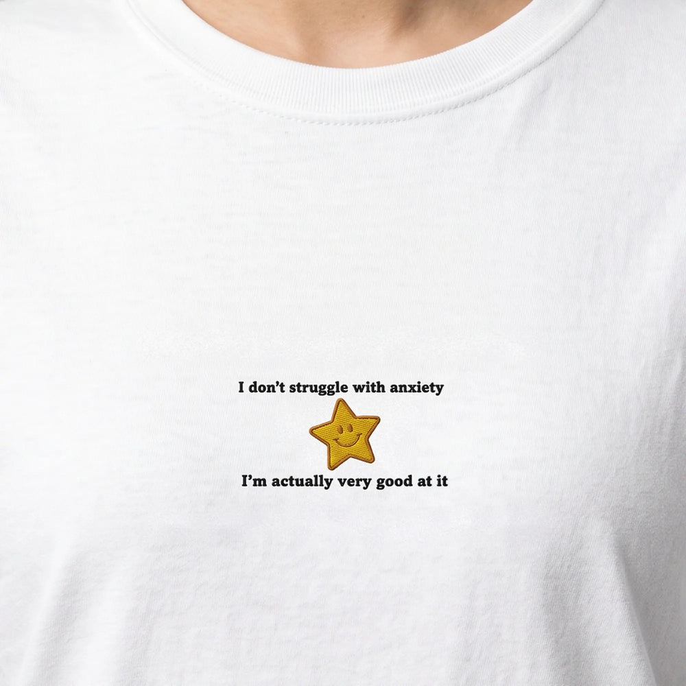I don't struggle with anxiety embroidered t-shirt, worn, close-up of the stitching