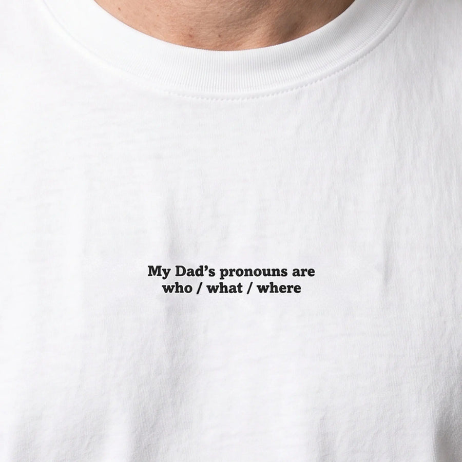 My Dad's pronouns are who what where embroidered t-shirt in white, worn, close-up of the stitching