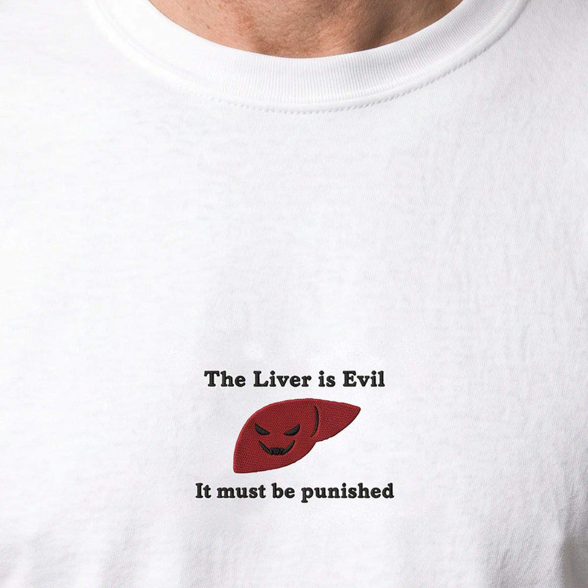 The Liver is Evil and must be punished embroidered t-shirt, worn, close-up of the stitching