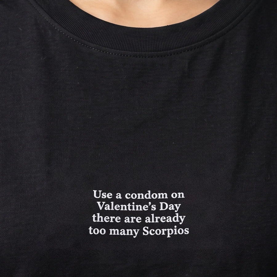 Use a condom on Valentine's Day there are already too many Scorpios embroidered t-shirt, worn, close-up of the stitching