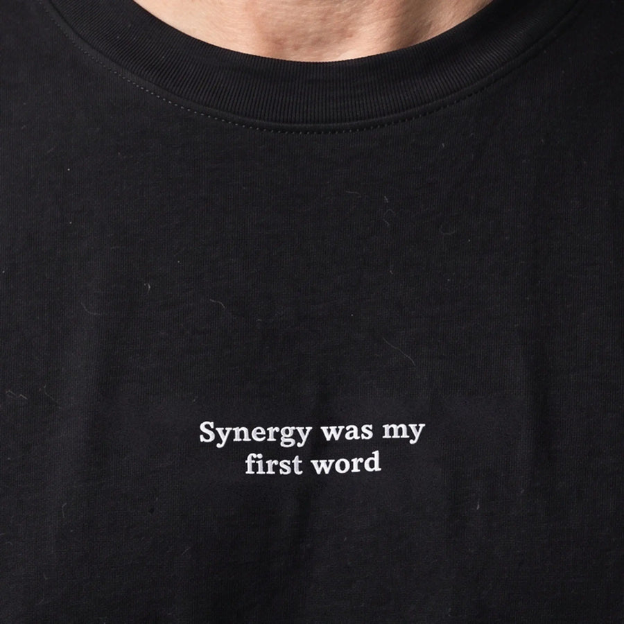 Synergy was my first word embroidered t-shirt, worn, close-up of the stitching