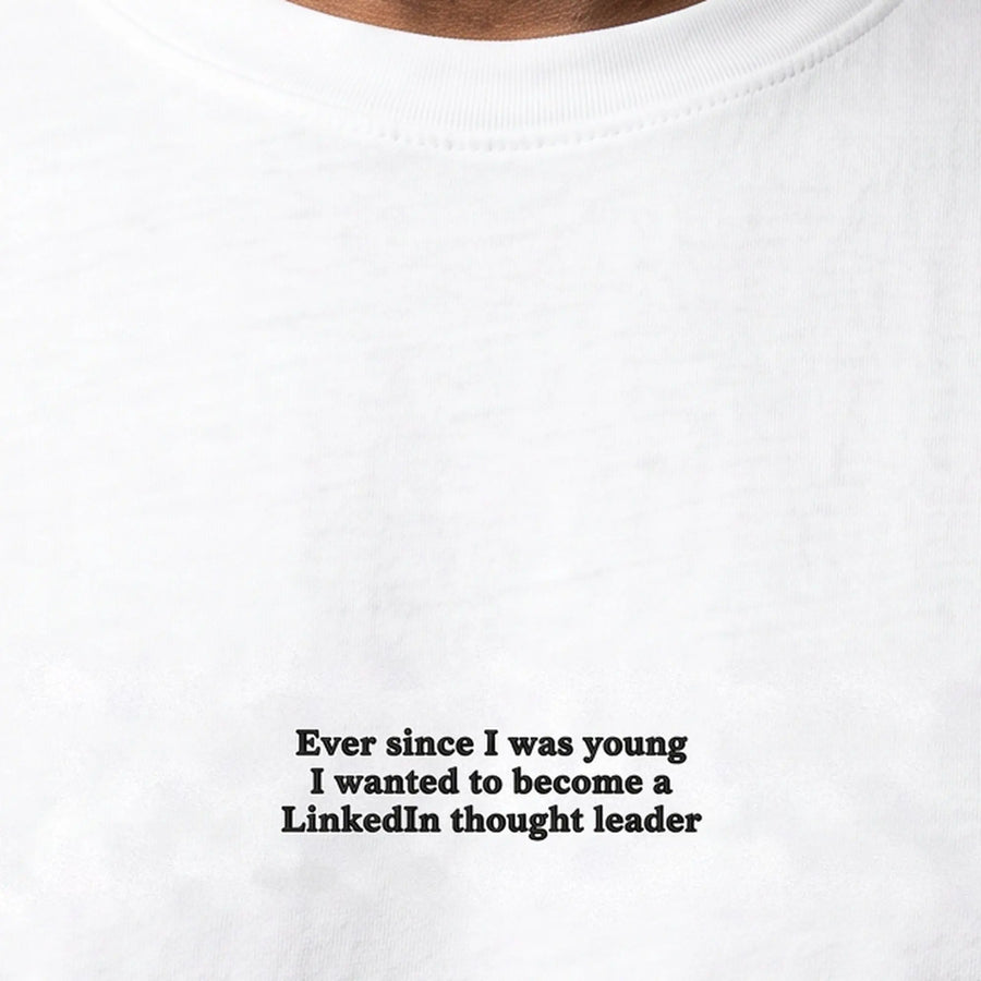Ever since I was young I wanted to become a LinkedIn thought leader embroidered t-shirt in white, worn, close-up of the stitching