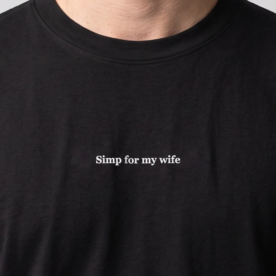 Simp for my wife (embroidered) T-Shirt in black, worn, close-up of the stitching