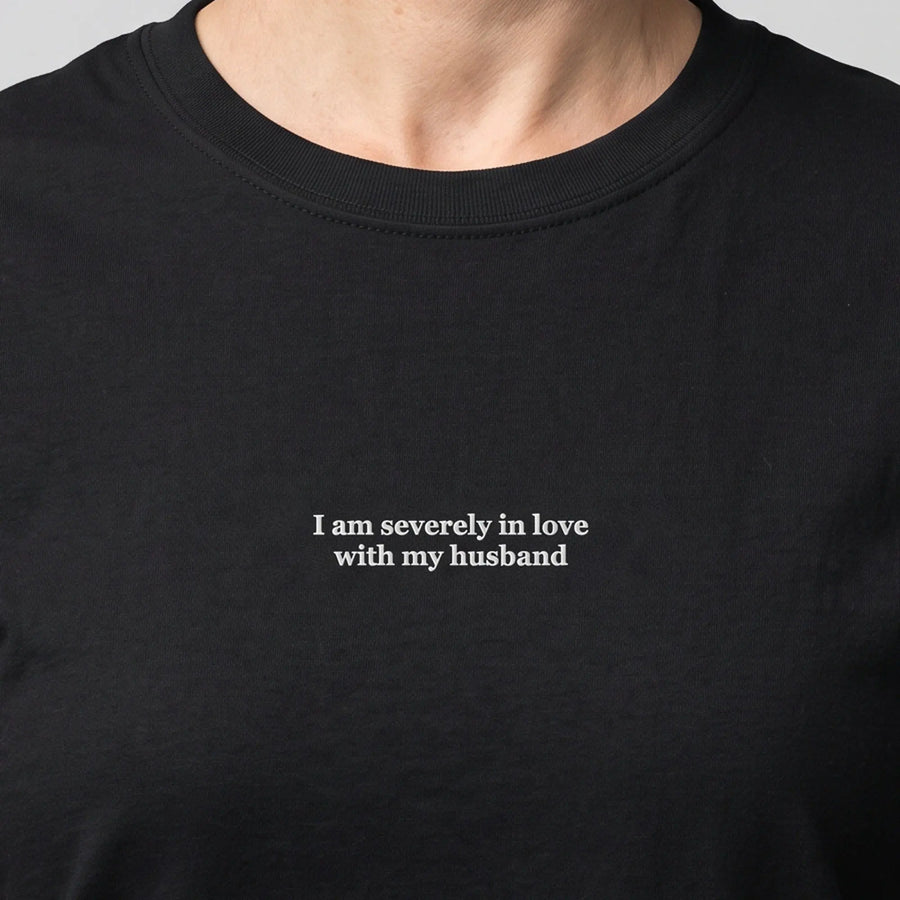 I am severely in love with my husband (embroidered) T-Shirt in black, worn, close-up of the stitching