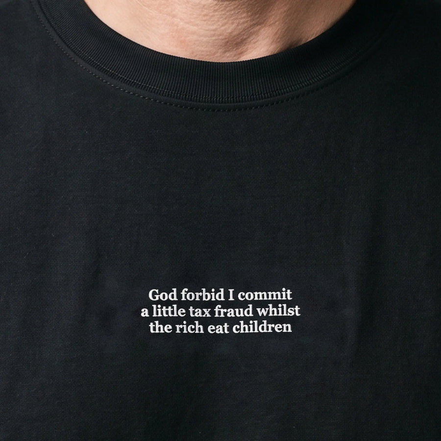 God forbid I commit a little tax fraud whilst the rich eat children (embroidered) T-Shirt in black, worn, close-up of the stitching
