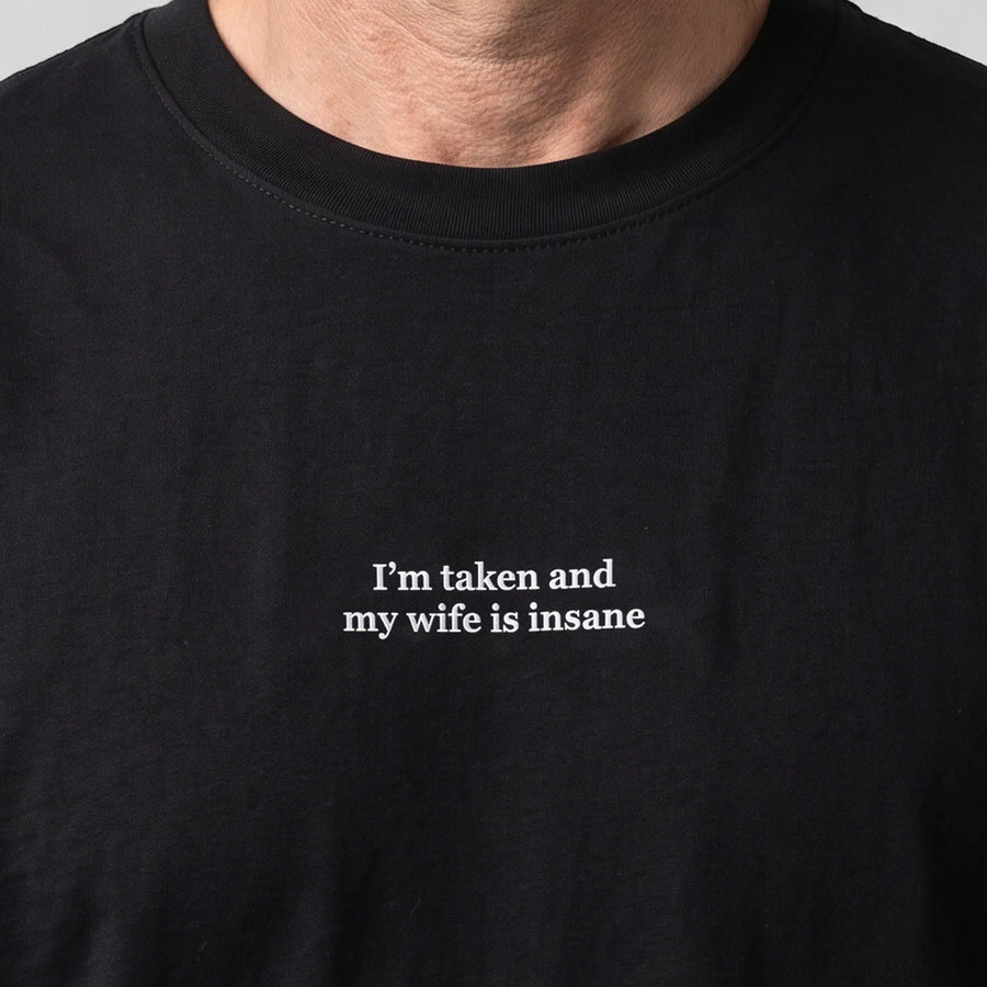 I'm taken and my wife is insane (embroidered) T-Shirt in black, worn, close-up of the stitching