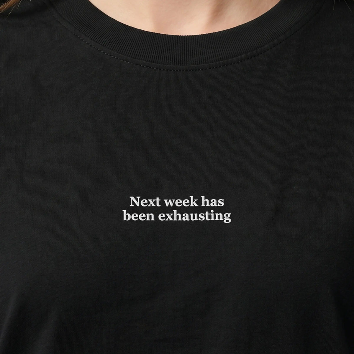 Next week has been exhausting (embroidered) T-Shirt in Black, worn, close-up of the stitching