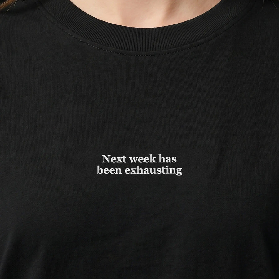 Next week has been exhausting (embroidered) T-Shirt in Black, worn, close-up of the stitching