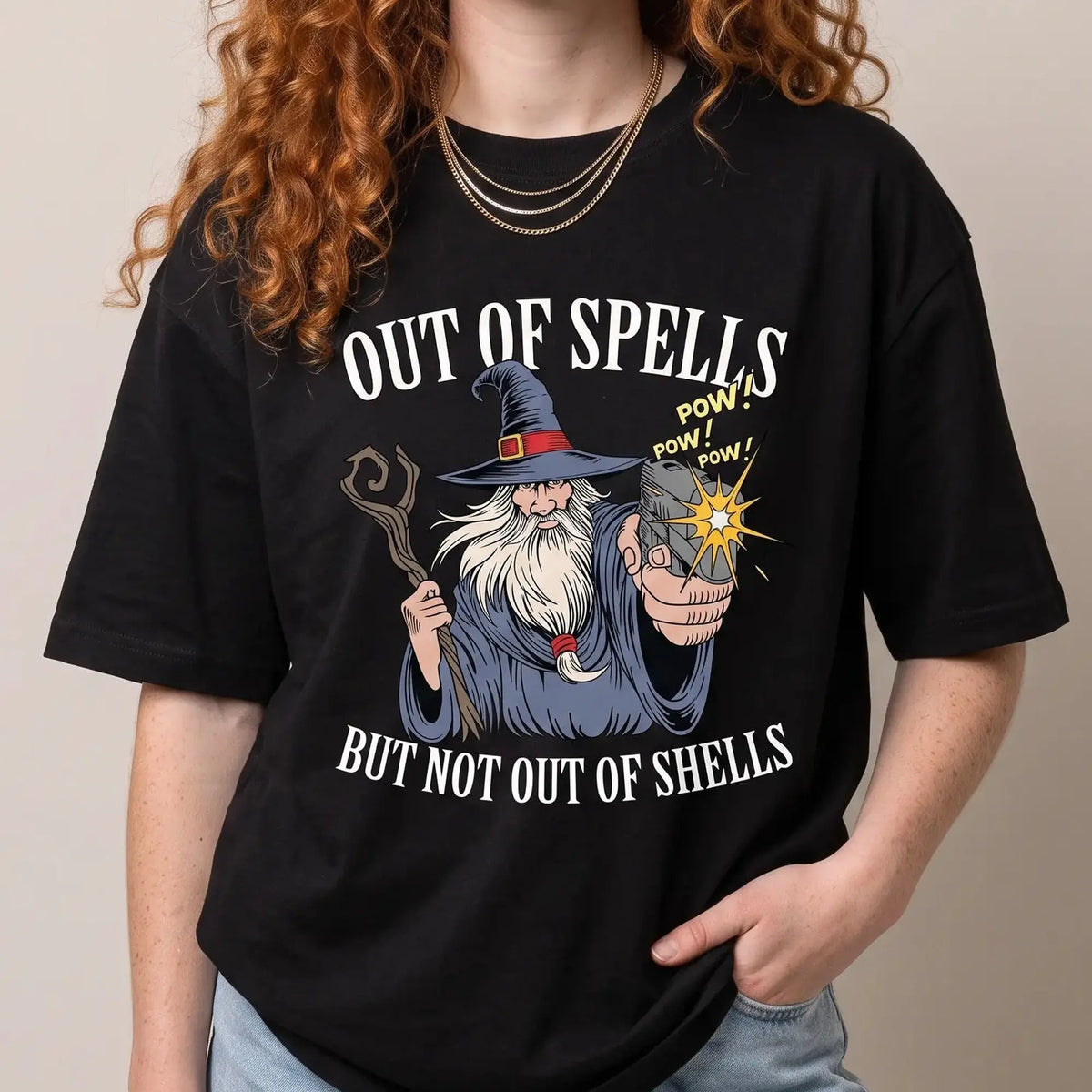 Model wearing the Out of Spells but Not Out of Shells T-Shirt in black, studio photo