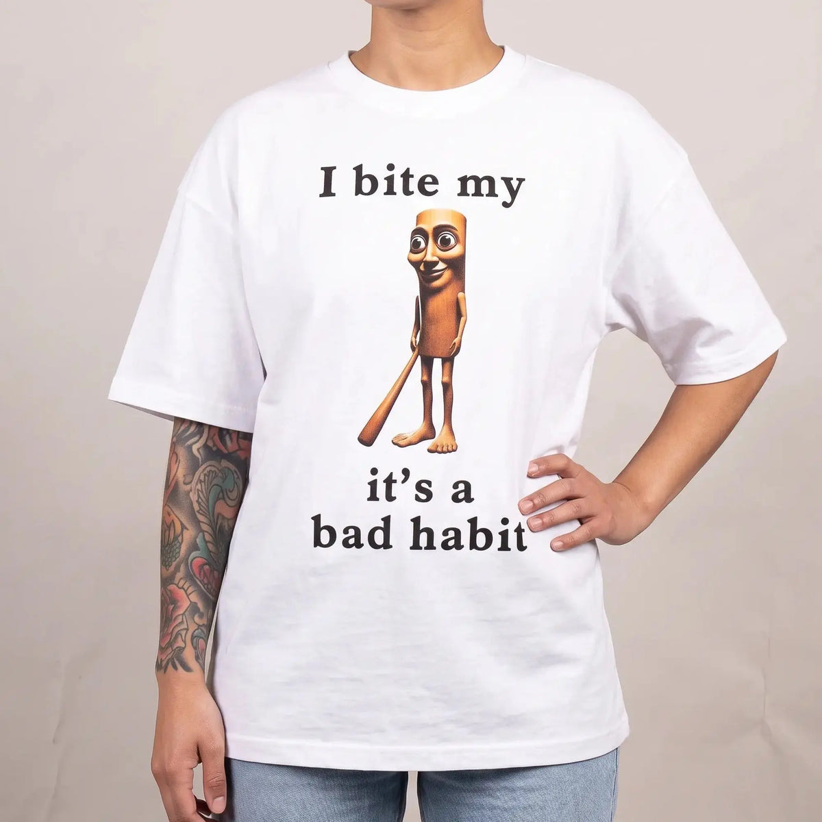 Model wearing the I bit my Tung it's a bad habit T-Shirt in white, studio photo