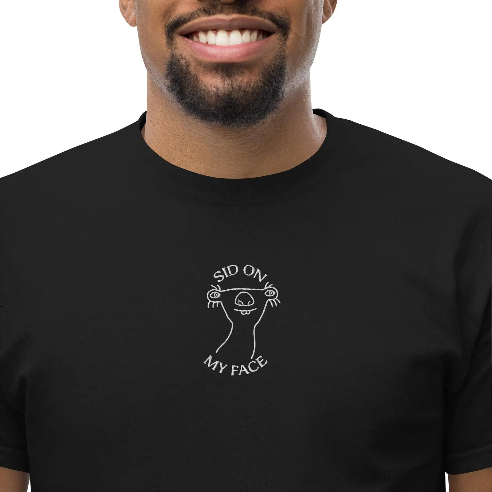 Person wearing a black t-shirt with a white graphic design on a white background
